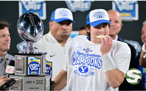 BYU QB eating Pop-Tart with the trophy